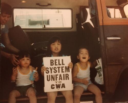 [Clark, Charity, Charles inside of VW bus protesting in support of Pacific Bell workers on strike]