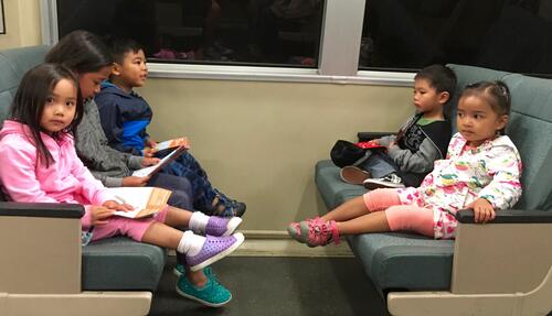 [Siblings, Jesela and Keanae, family friends riding BART for the first time on the way to Chinatown]