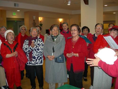 [Members of Damayan community singing a medley of Filipino folk and Christmas songs]