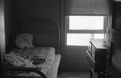 [Planters Hotel, 286 Second Street, interior of  a room showing bed, window, and dresser]