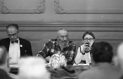 [George Woolf (center) on panel at a meeting of Tenants and Owners in Opposition to Redevelopment (TOOR) at Milner Hotel,