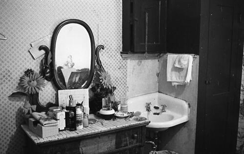 [Lee Washington's room in Daton Hotel, 175 3rd Street, personal items atop dresser next to sink]