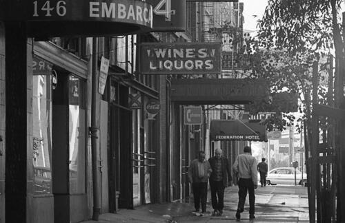 [Hotels and businesses and people walking on the 100 block of Embarcadero]