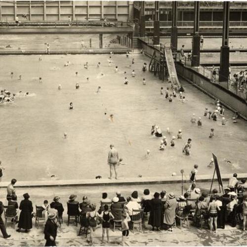 [People swimming in wading pool at the Sutro Baths]