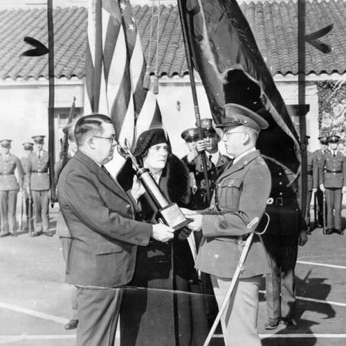 [Mr. and Mrs. Harry Marshall presenting Cadet Lieutenant Colonel Ralph E. Schultz a memorial trophy in honor of the Polytechnic High School R. O. T. C.]