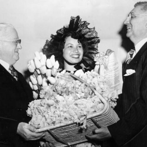 [Ansel Robinson and Elsie Jaquet presenting Mayor Elmer E. Robinson with flowers]