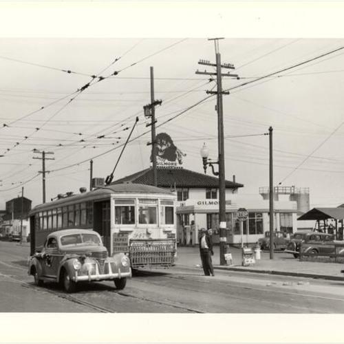[Third and 18th streets looking north at northbound #16 car 947 passing Gilmore gas station]