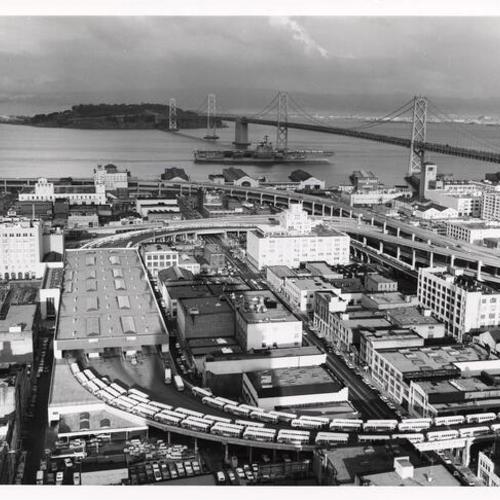 [Aerial view of Transbay Transit Terminal, with San Francisco-Oakland Bay Bridge in background]