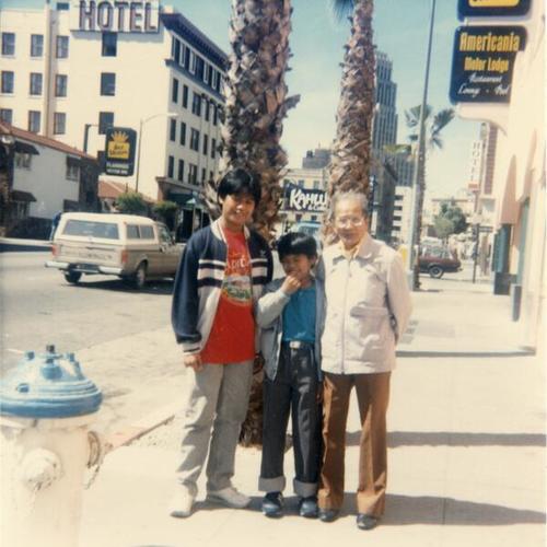 [Gene with his brother and father standing at 7th Street and Minna]