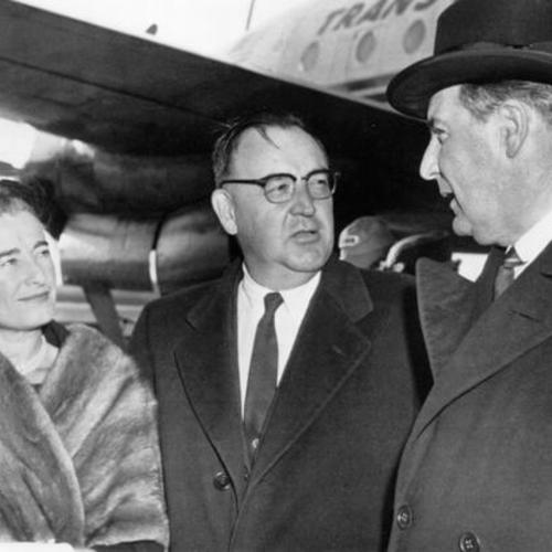 Governor-elect Pat Brown (center) and his wife are met in Kansas City by Governor James Blair of Montana]