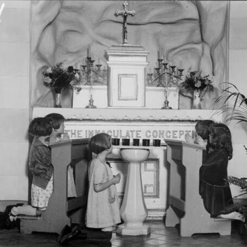 [Five children praying at St. Charles School]