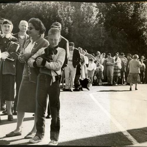 [People in line at McLaren Lodge in Golden Gate Park waiting to signup for sites at Camp Mather]