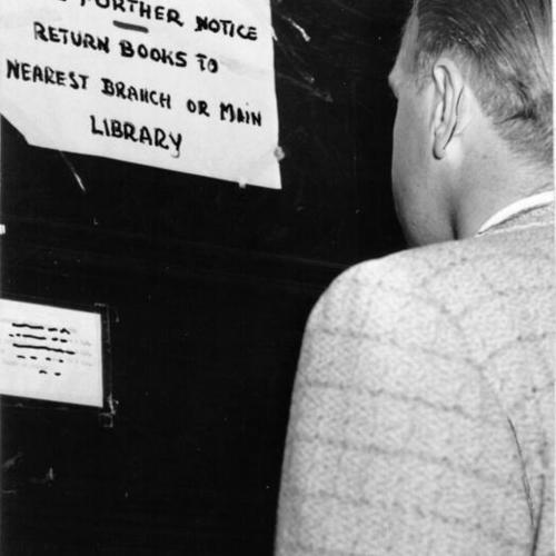 [Man looking at closed sign on McCreery Branch Library]