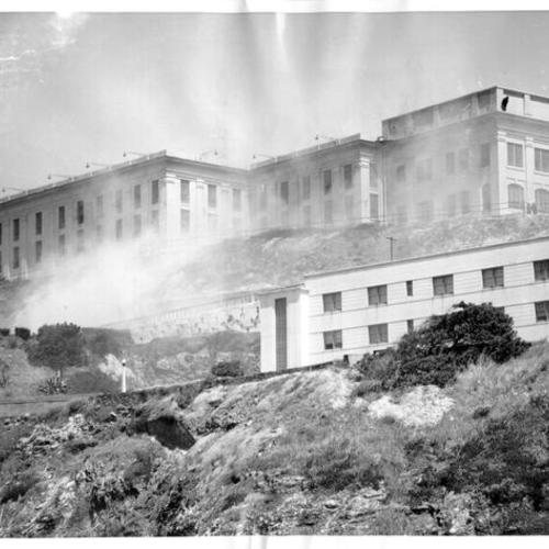 [Tear gas and rifle grenade smoke surrounding the Alcatraz Prison cell block during a 3 day prisoner revolt in May, 1946]