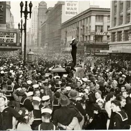 [People celebrating the end of World War II at Market and Mason streets]