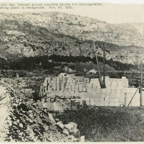 Hetch Hetchy dam. Precast porous concrete blocks for drainage wells. Rock crushing plant in background