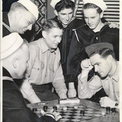 [Group of servicemen playing and "kibitzing" at the Army-Navy Branch of Y.M.C.A.]