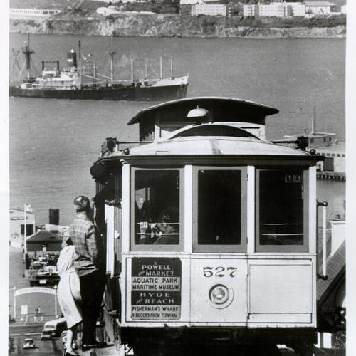 [View of cable car on Hyde Street, with Alcatraz Island in the background]