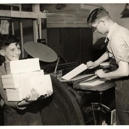 [Robert McCologan and Russell Beaumont working at the Boys Club Printing Department]