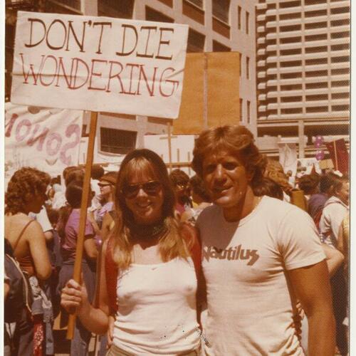Frances FitzGerald and Dave Kopay at Gay Freedom Day Parade, Frances holds a sign that reads "Don't Die Wondering"