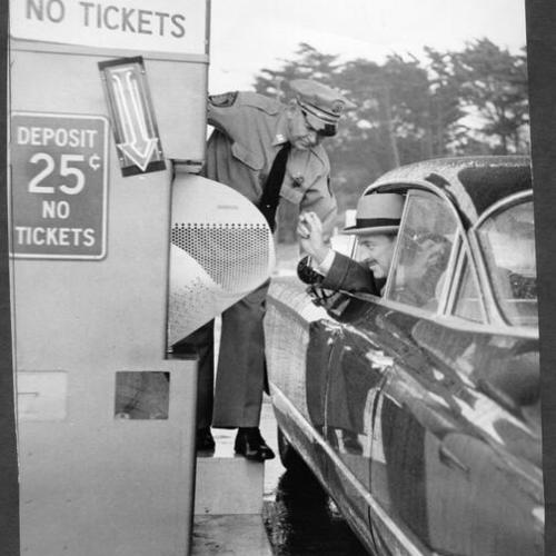 [Director Dan London and Captain Ray Logan testing automatic toll collection machines installed on Golden Gate Bridge]