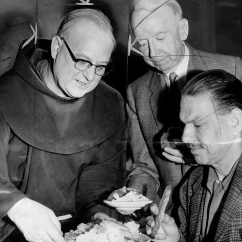 [Father Alfred Boeddeker, kitchen executive director, serving meals at St. Anthony's dining room]