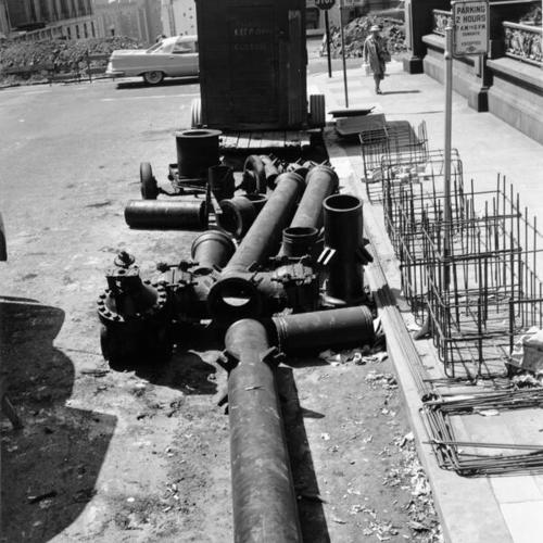 [Water pipes laying on the street at the intersection of Mason and California]