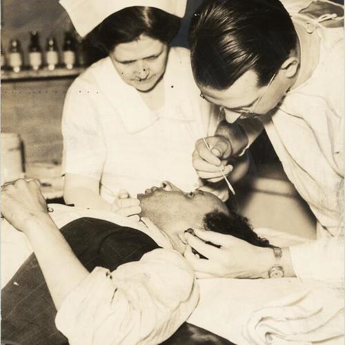 [David Del Fosse receiving medical treatment in a hospital after being injured in longshoremen's strike]