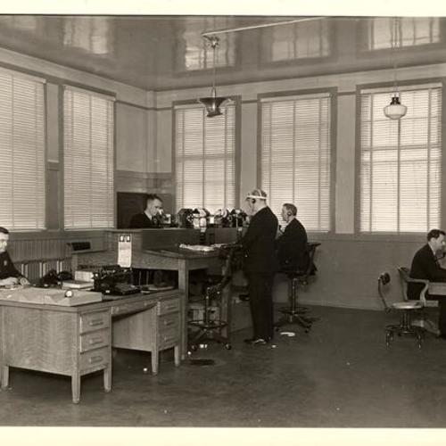 [Officers working at the communication room in Old Hall of Justice]