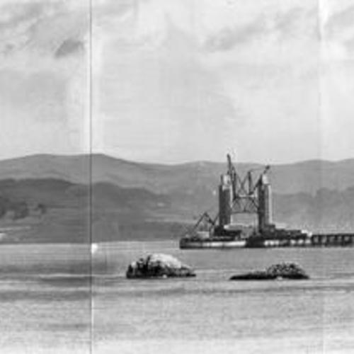 [Panoramic view of the Golden Gate Bridge towers under construction]
