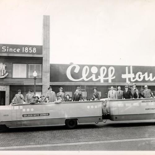 [Group of people riding the Elephant Train in front of the Cliff House]