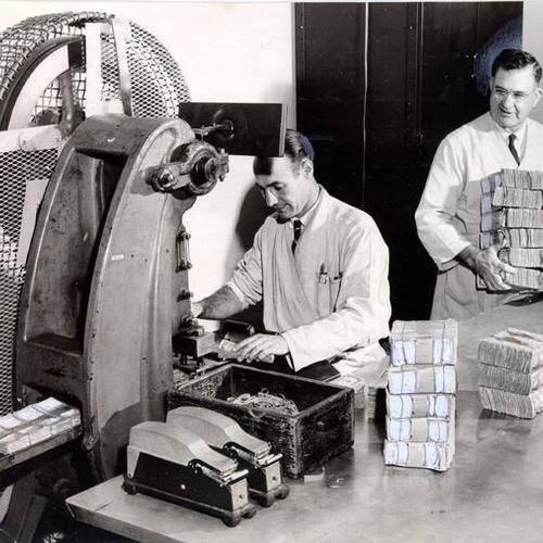 [Federal Reserve Bank employees Vernon Boysen and M. E. Stevenson destroying money]
