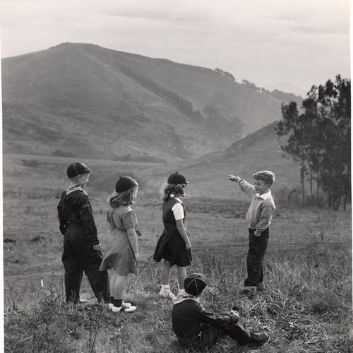 [Kids standing in a field]