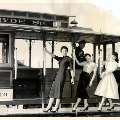 [Francine Yerrick, Lynda Scott and Pat Strasser riding a Powell and Hyde streets line cable car]