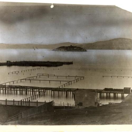 [View of Meigg's Wharf with Alcatraz Island in background]