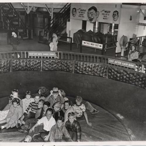 [Charles Coryell and a group of children from his neighborhood on a ride at Playland at the Beach]