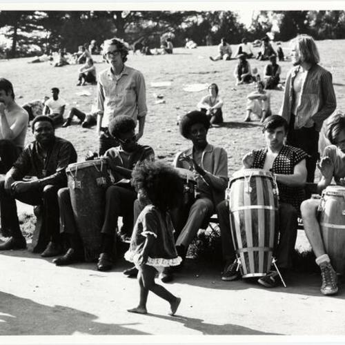 [Musicians playing on bench by "Hippie Hill" in Golden Gate Park]