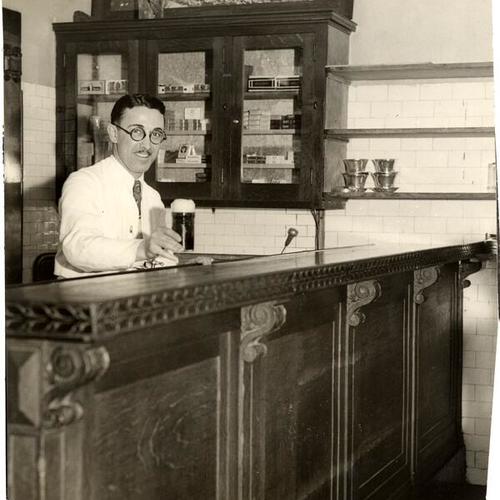 [Bartender serving a drink at the St. Francis Hotel bar]