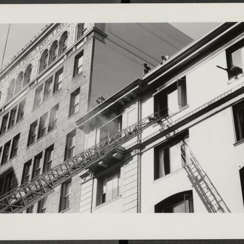 Fire engine with aerial ladder deployed into Grand Hotel at 57 Taylor Street