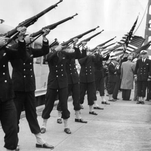 [Cadets from Maritime Academy  in Vallejo firing gun salute in a memorial ceremony honoring merchant marines, on the center span of Golden Gate Bridge]