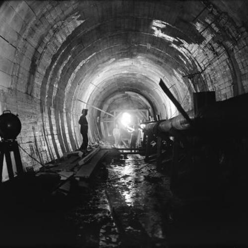 [Shows arch forms being erected at up stream end of tunnel and trestle carrying water line to pit No. 6 and drain pipe]