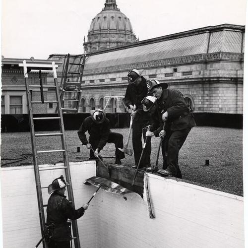 [Group of firemen from Truck 5 working on top of the War Memorial Building]