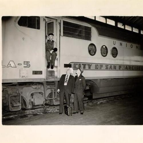 [J. O. Hand, G. E. Gaylord and Garrett King standing next to the "City of San Francisco" streamlined train]