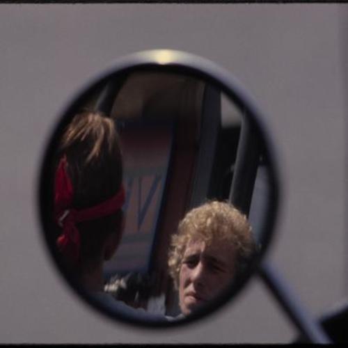 View of people through rearview mirror
