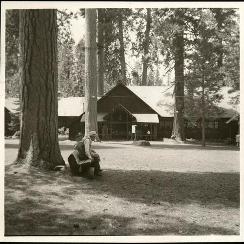 [Campers sitting near lodge at Camp Mather]