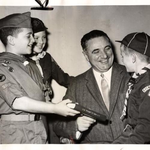 [Scouts Bill Rothschild, Michael Shrum and Kent Guyman presenting Mayor Christopher an official handbook on the occasion of the 50th anniversary of Boy Scouts of America]