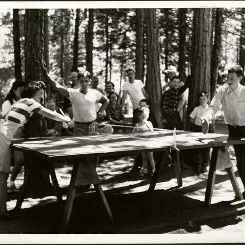 [People watching ping-pong players at Camp Mather]