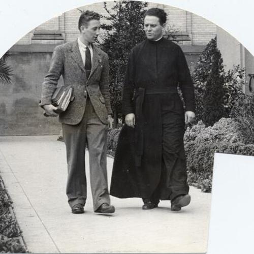 [Student Malcolm McCarthy walking with Father Giamastiani at the University of San Francisco]