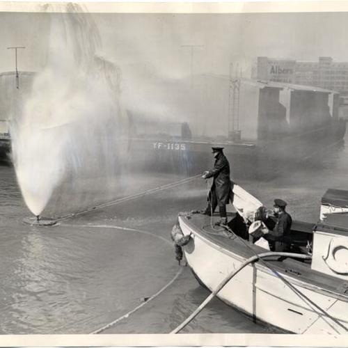 [Oakland Naval Supply Depot firemen demonstrate the new jet propelled creeper]