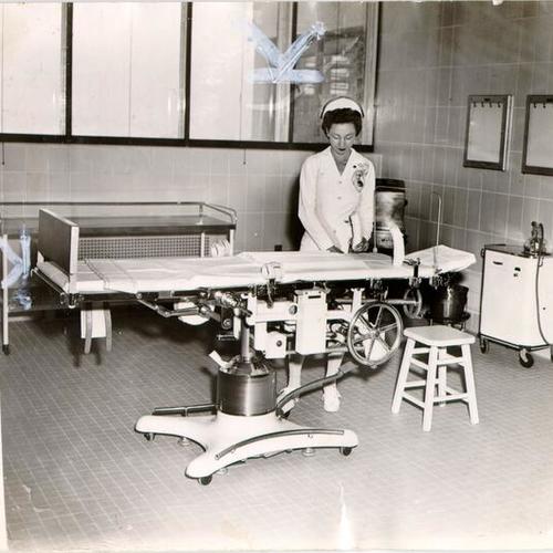 [Surgical Nurse Marie Callori checking equipment in an operating room at Langley Porter Clinic]